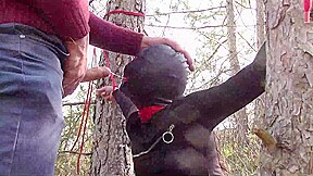 Tied to a tree on a sexy outfit, masked and outdoor deepthroat with no mercy