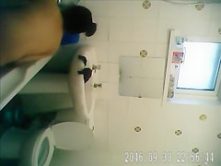 Bathing woman washes her long dark hair