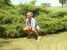 blonde peeing on the beach