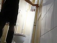 Chick lifts dress in bathroom