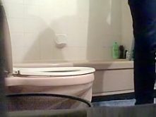 Girl seating and peeing in toilet