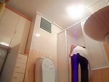 Hot busty woman undressing before shower