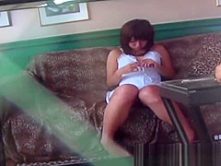 Japanese chick plays with her pussy while watching hot porn