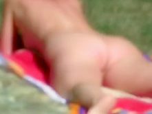 Nude woman spied while sunbathing