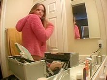 Topless daughter applying makeup