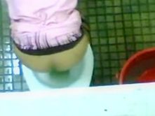 Urinating girl filmed over the bathroom wall