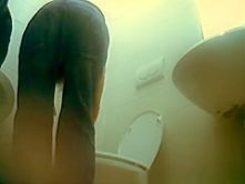 Woman in glasses and jeans pants spied pissing