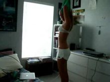 Beautiful young blonde dancing in the bathroom