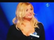 Blonde woman with big juggs gives the audience an eyeful of her melons and ass