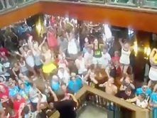 German girls dance in bikini on tables in a bar and flash their tits