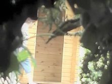 Pissing older woman zoomed by a voyeur