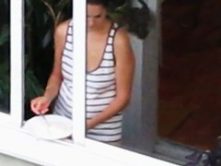 sexy bird in the window making cereal wearing a thong