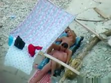 Voyeur tapes a nudist couple having oral sex at the beach