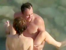 Voyeur tapes a nudist couple having sex in the sea